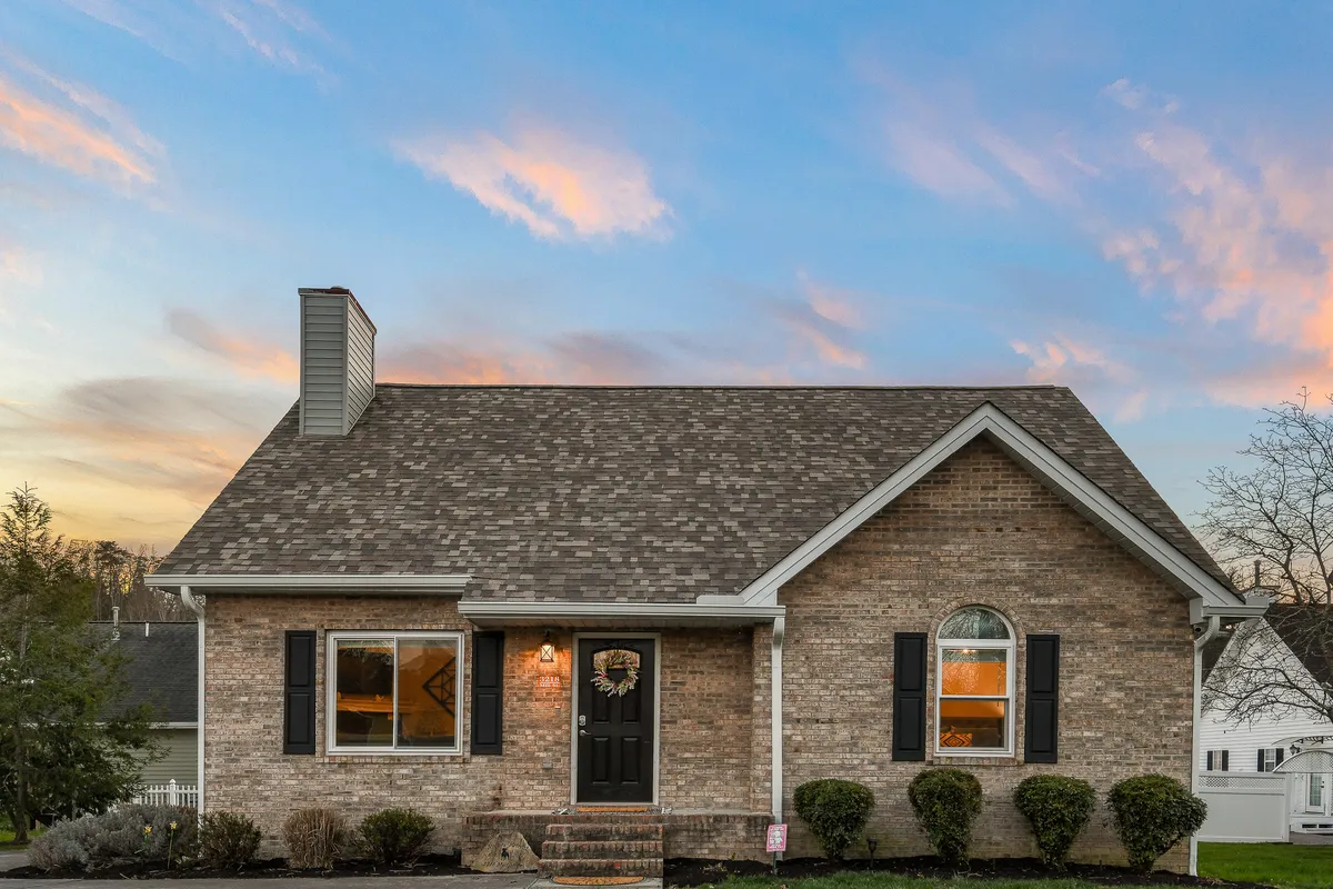 A view of the front door and arched window with a landscaped yard, suggesting ample space for outdoor activities and strolls. The inviting exterior hints at opportunities for family and pet enjoyment, with a relaxed atmosphere for gathering or play.